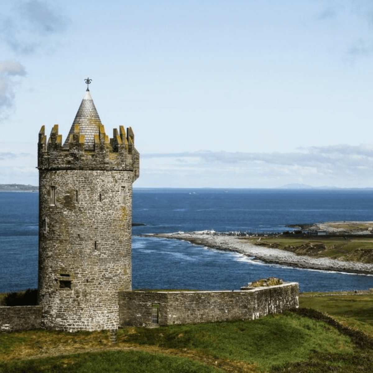The coast of doolin with a view of the sea and an old castle 