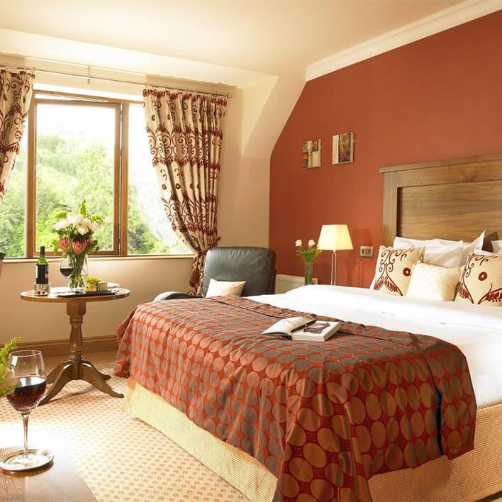 The interior design of a double room in the Glengarriff Park Hotel with wine displayed also in the room
