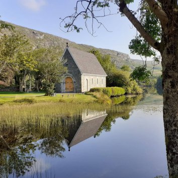 Saint Finbarr's Chapel reflected in the lake at Gougane Barra in Ireland