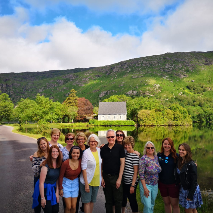 A group of guests standing outside the church in gougane barra