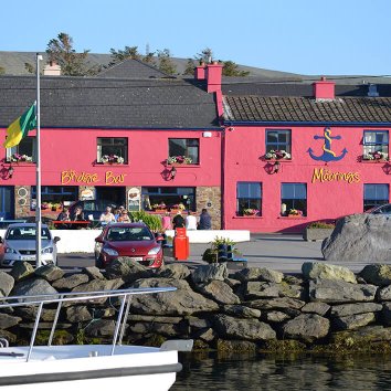 The exterior front view of the Moorings Guesthouse directly across from the harbour