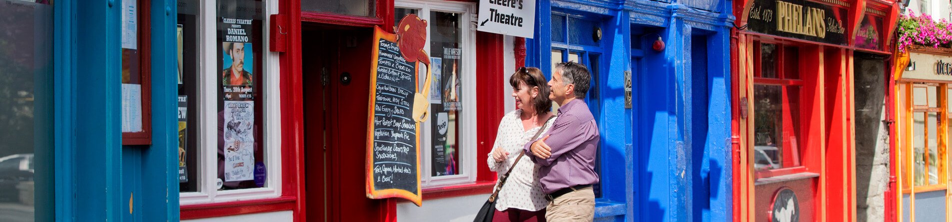 Couple browsing colourful shops in Kilkenny, Ireland
