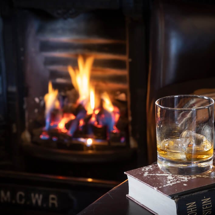 Whiskey glass in front of fire