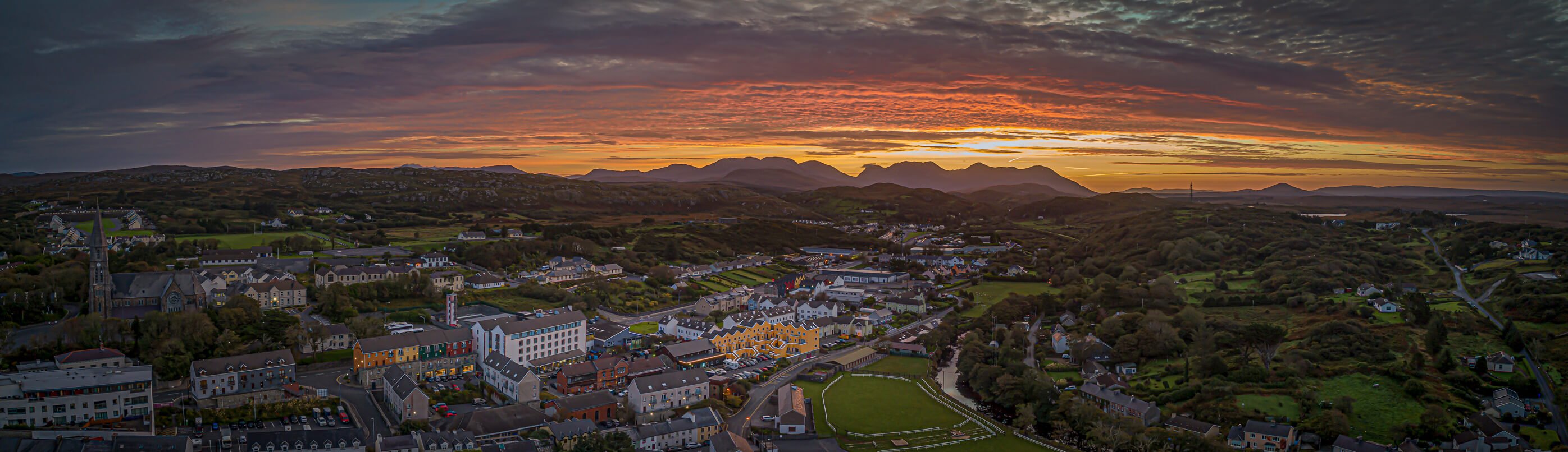 Spectacular aerial drone shot of sunrise over Clifden in Ireland