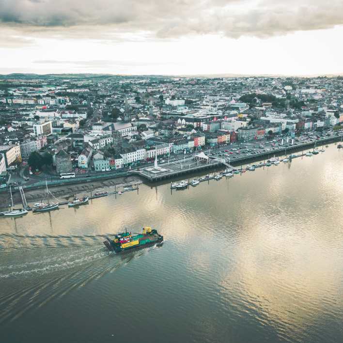 An aerial view of waterford city with a boat on the river