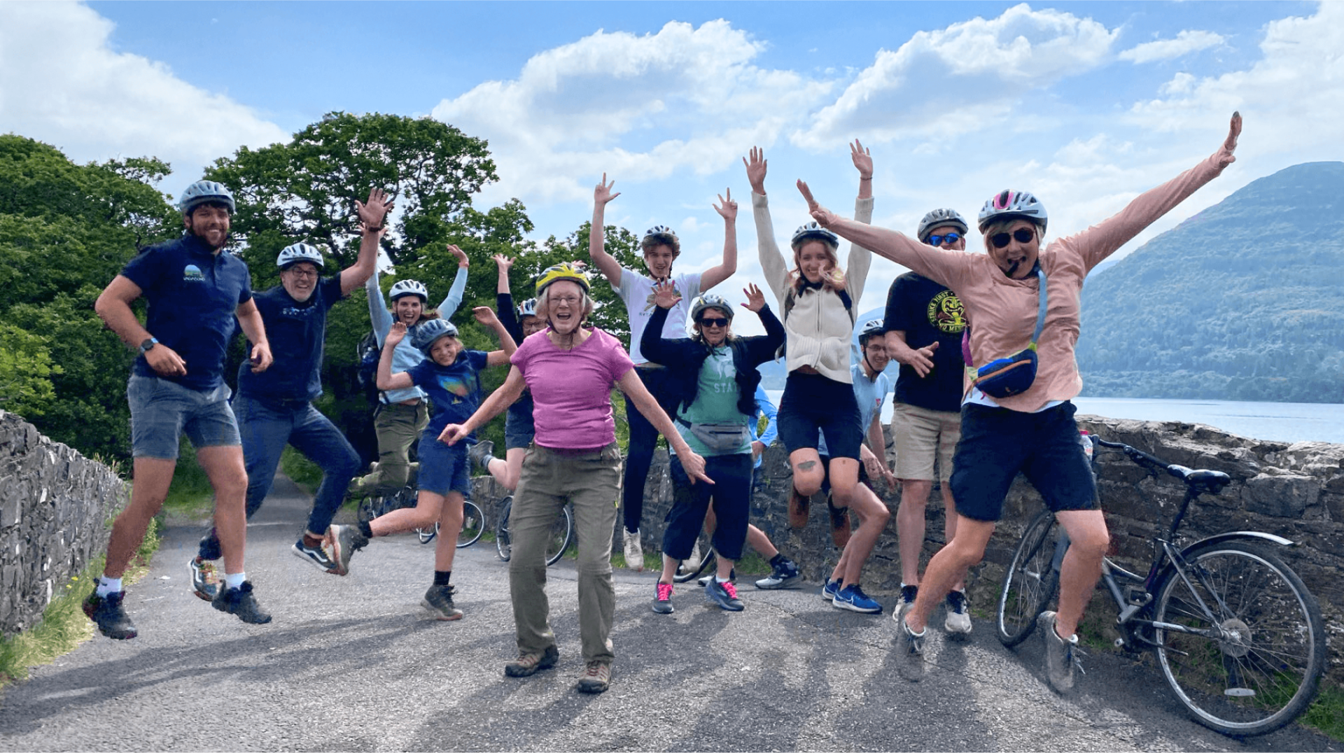 A group jumping for joy in Killarney National Park on their cycling tour 