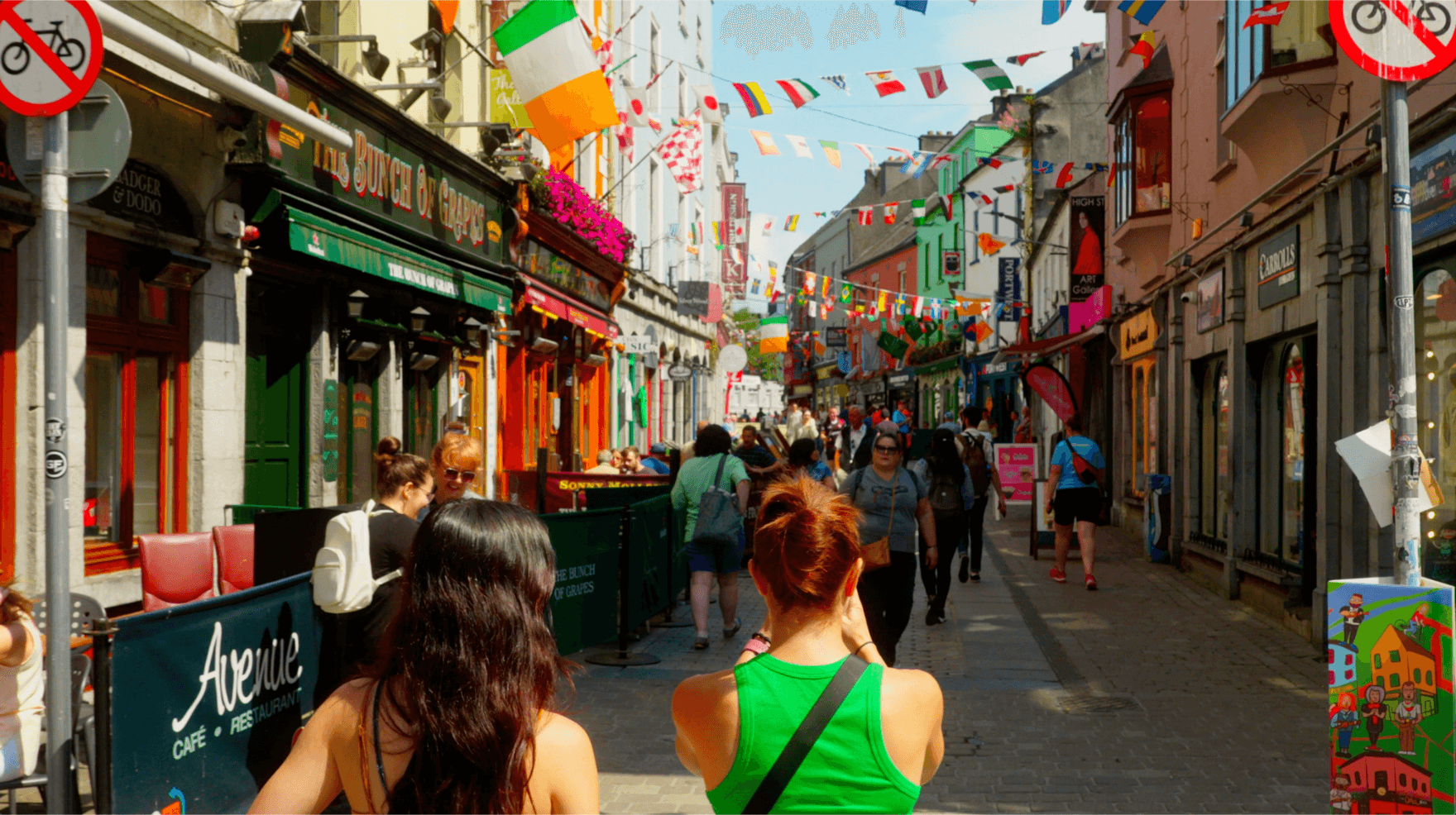 Two guests walking through shop street in galway