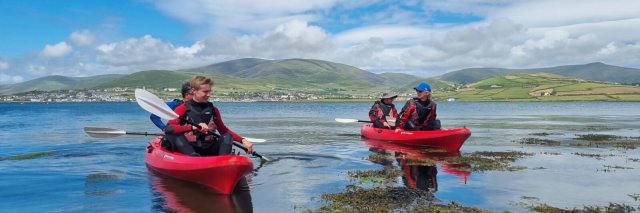 Two sea kayaks with tour guests on the sea in Ireland