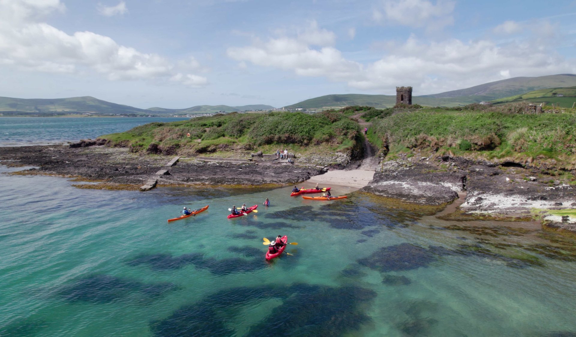 An aerial view of a vagabond group kayaking on Dingle Bay