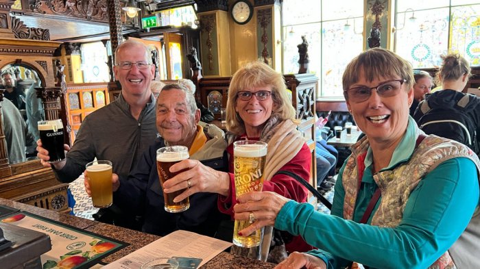Happy group toasting pints of beer in Ireland