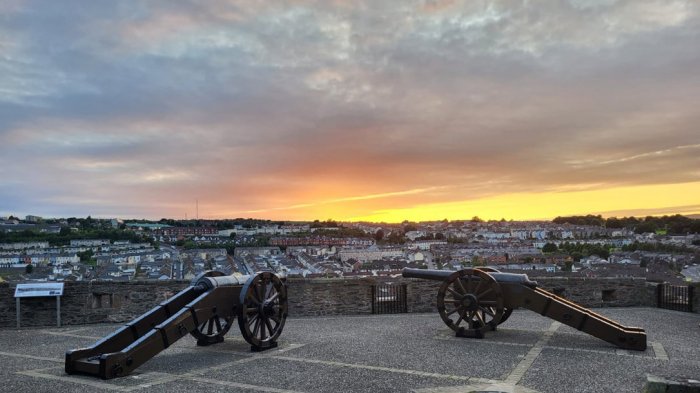 Canon on the walls of Derry/Londonderry in Northern Ireland with a sunset in the background