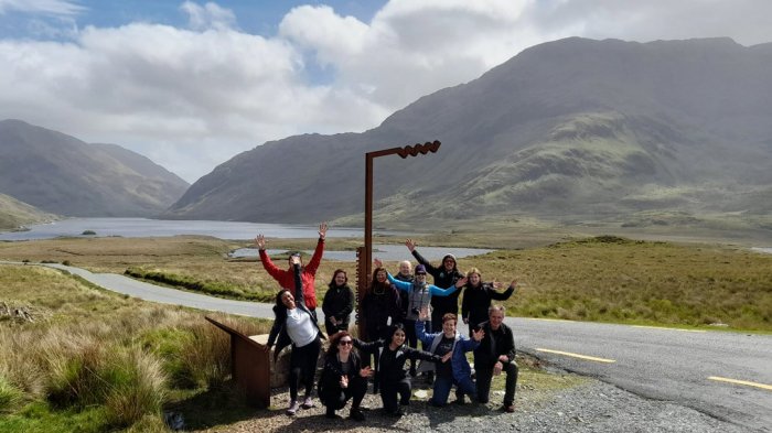 Happy tour group in Doolough Valley in Ireland