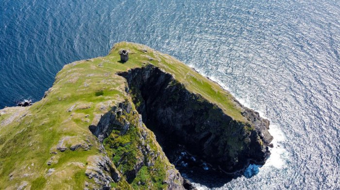 Aerial drone shot of headland and ruin at Slieve League cliffs in Donegal, Ireland