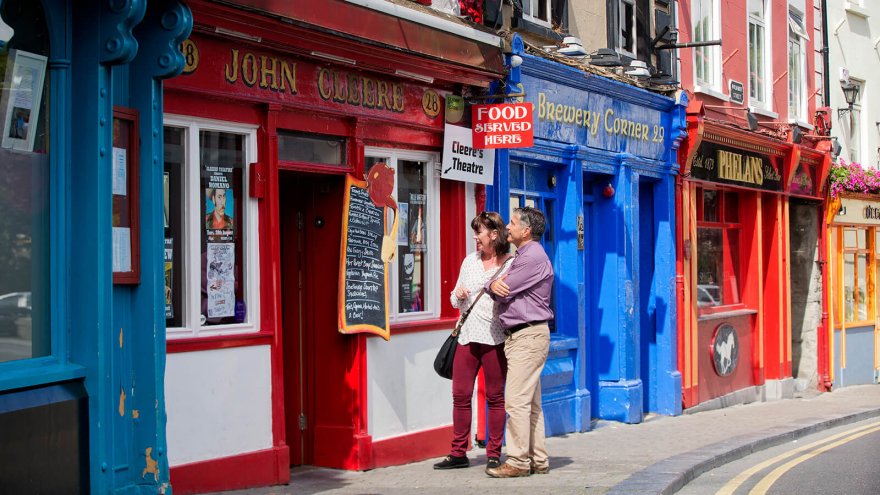 Couple exploring colourful shops in Kilkenny, Ireland