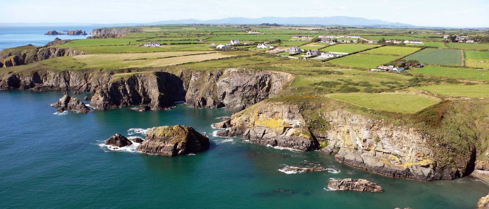 Copper Coast in Waterford with green patchwork fields and cliffs