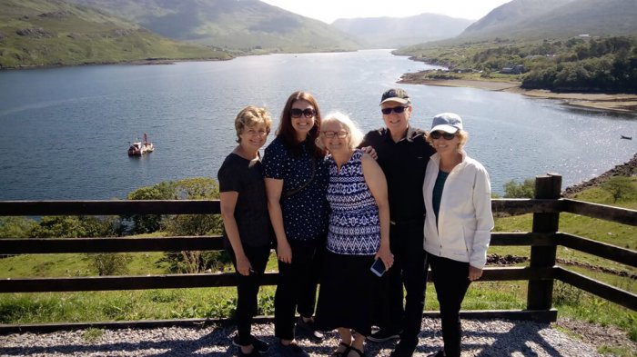 Guests at Killary sheep farm overlooking the fjord in the sunshine
