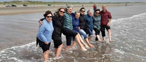 11 Day tour group having fun on the beach in Ireland