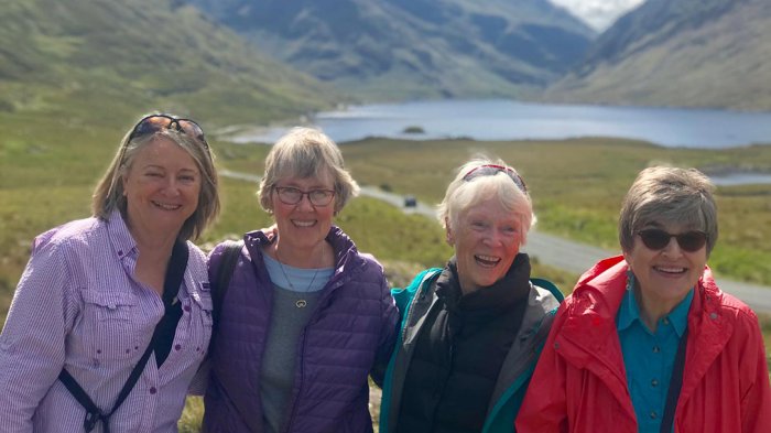 Four smiling female friends on tour in Ireland