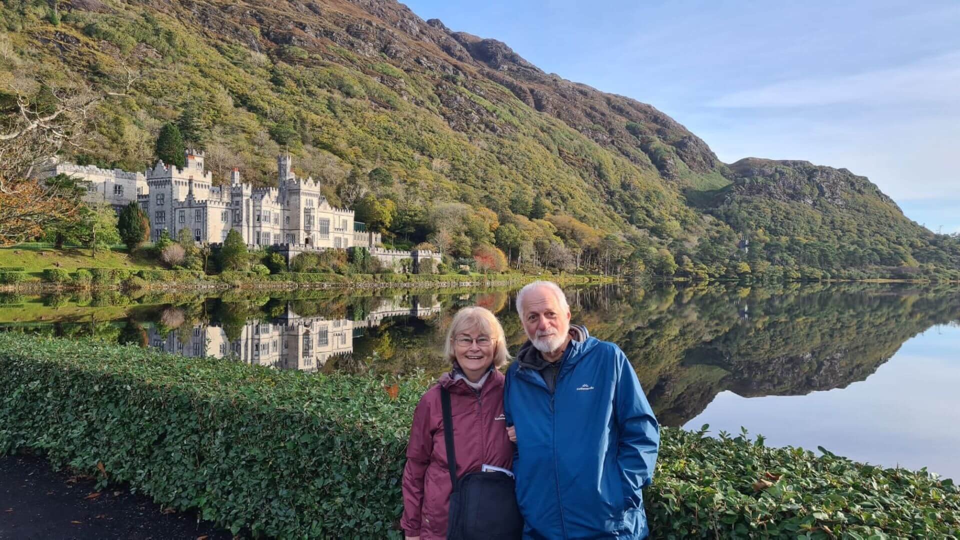 A couple in front of kylemore abbey