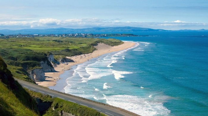 A scenic view of beach and ocean on the Northern Ireland coastline
