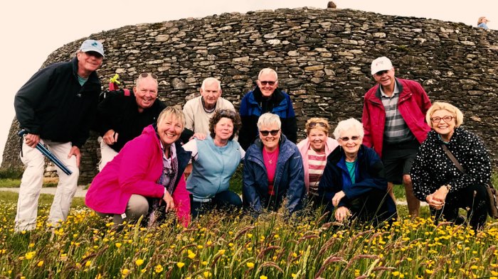 Smiling tour group at Grianan of Aileach in Donegal, Ireland