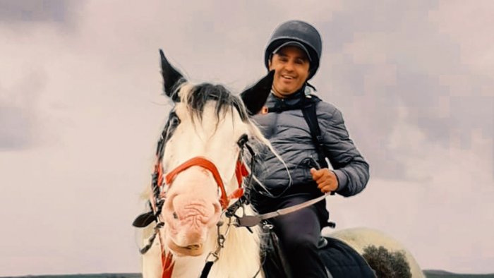 Smiling horseback-rider on a 2 week tour of Ireland