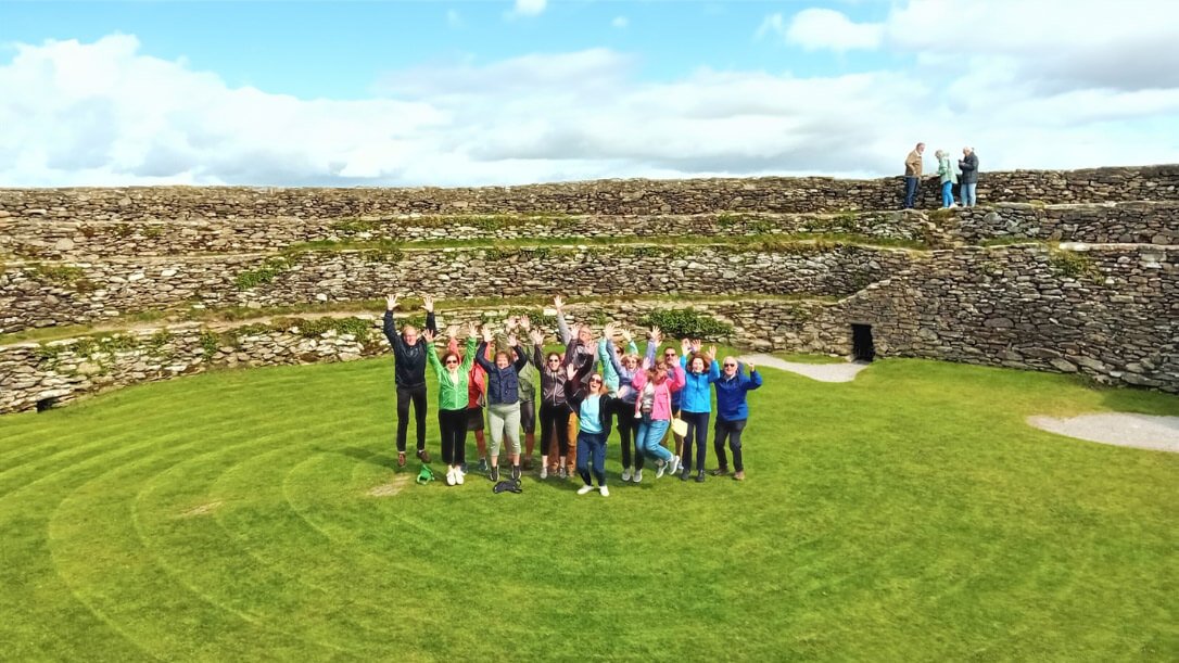 A tour group in the centre of an grianan of aileach