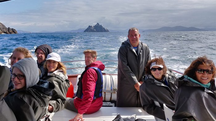 Tour group on a boat with Skellig Michael Island in the background