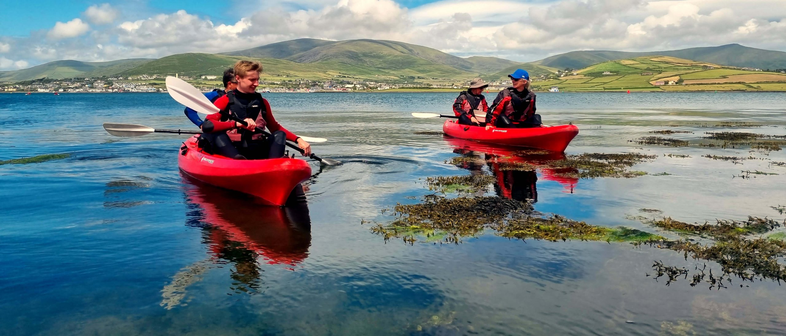 Scenic shot of adventure tour guests sea kayaking in Ireland