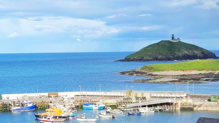 An island with a lighthouse and a harbour in Ballycotton, Cork, Ireland