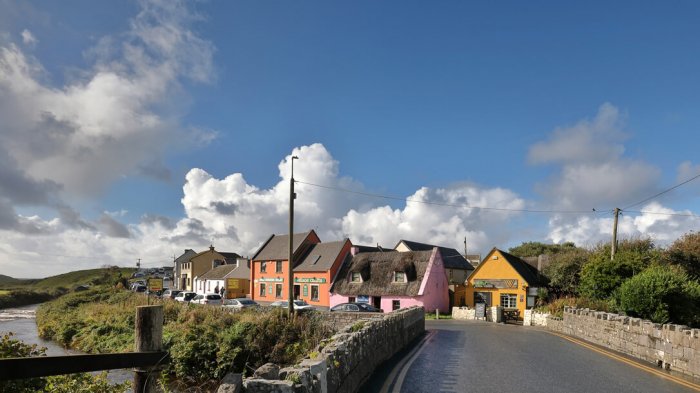 Colourful houses under a blue sky with clouds in Doolin, Ireland