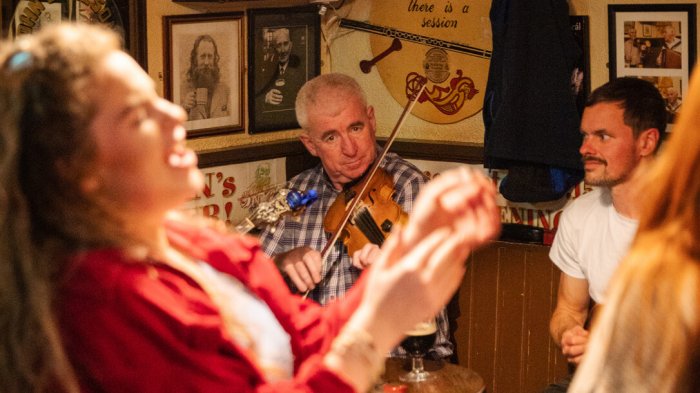 Singer with violinist in pub in Ireland