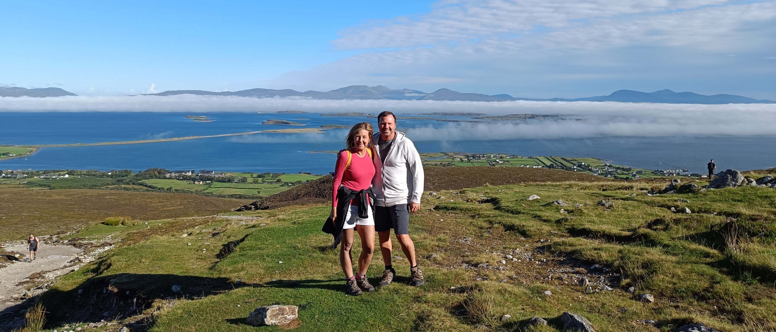 Two tour guests in scenic landscape in Ireland