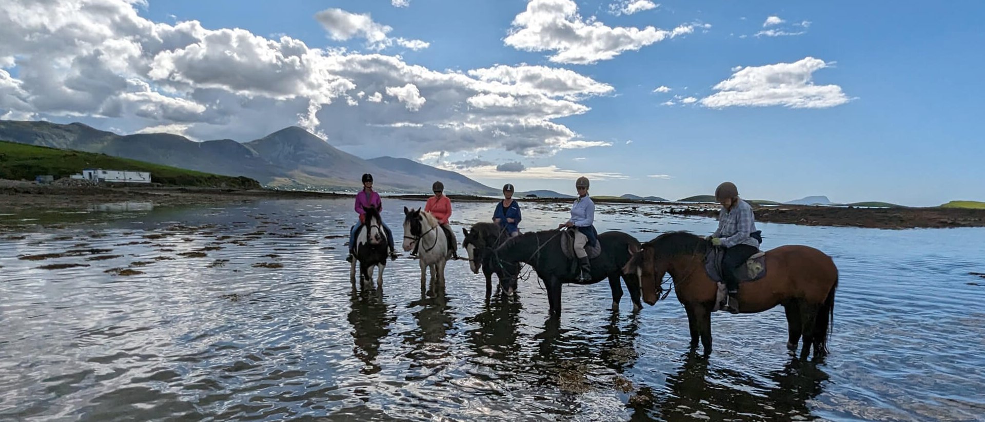 Horse-riding group in the sea on horseback near Westport, Ireland