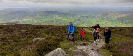 Tour group hiking Slieve Gullion mountain on an active vacation in Northern Ireland