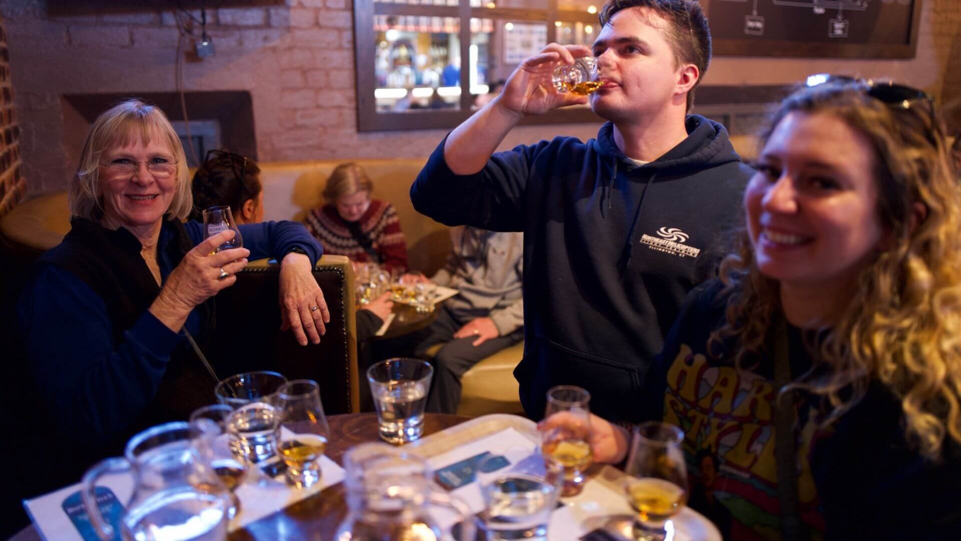 three people in bushmills whiskey doing a whiskey tasting