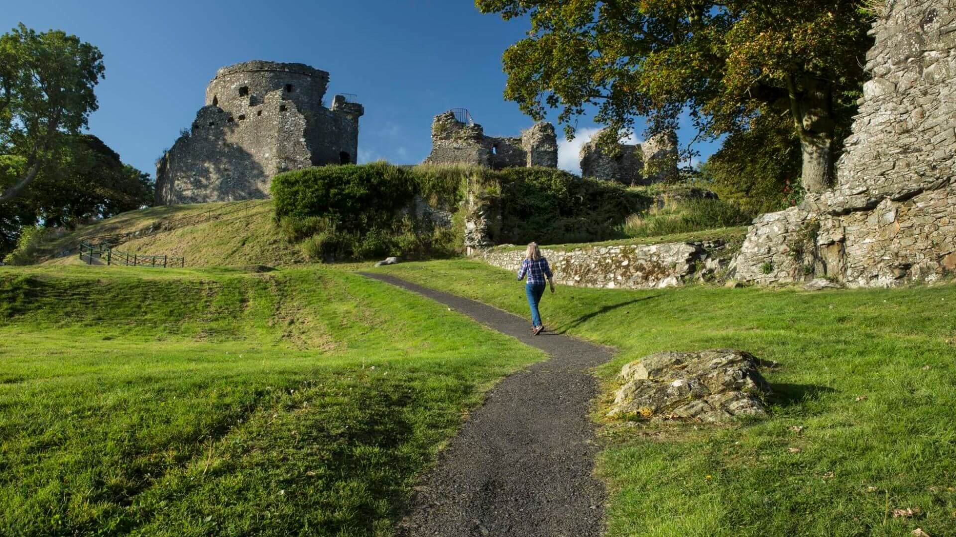 A lady walking uphill to dundrum castle