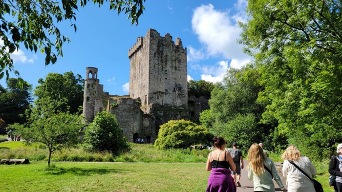 Three ladies walking towards blarney castle in the sun