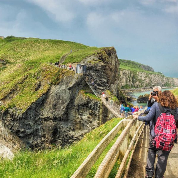 Guests crossing Carrick a rede rope bridge in Northern Ireland