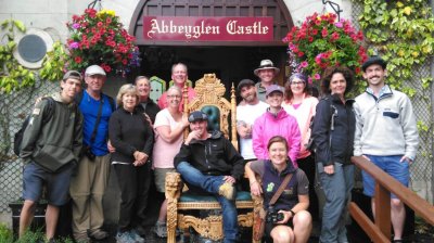 Vagabond Group posing in front of Abbeyglen Castle Hotel in Ireland with a throne