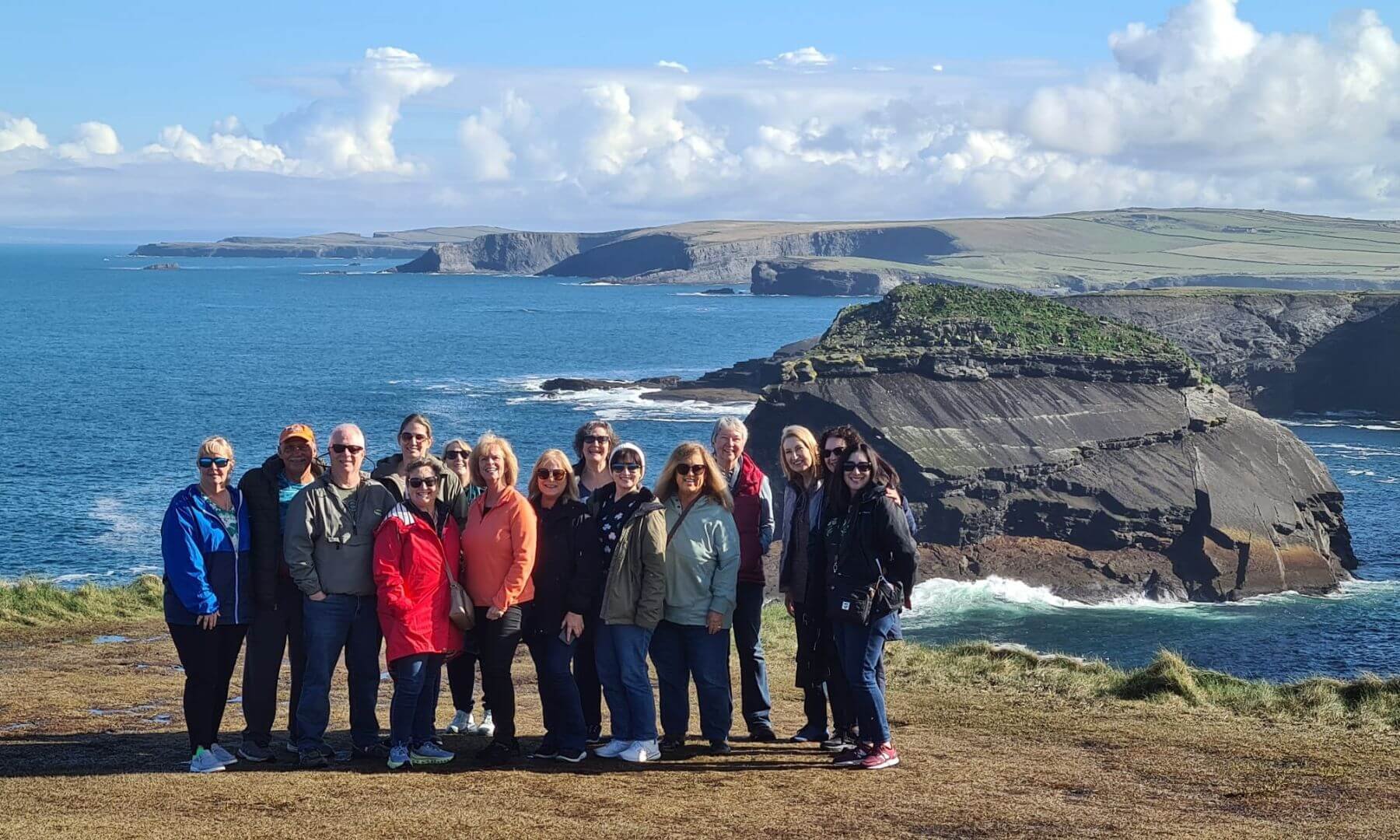 A group of guests standing on the edge of the dingle peninsula for a group photo