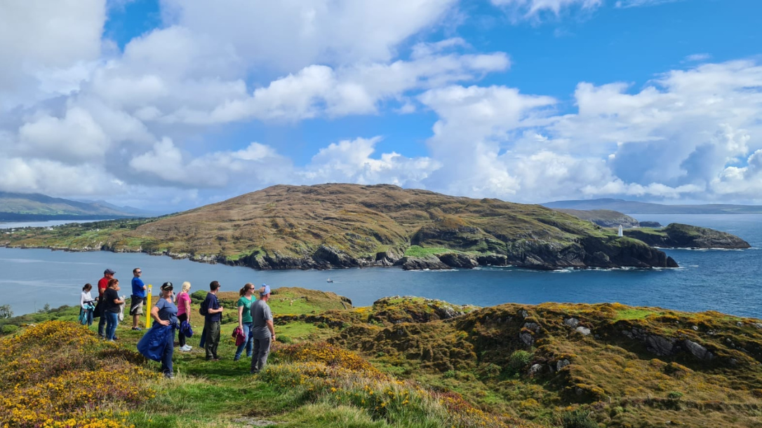 A group of guests looking out at bullig bay on their loop walk