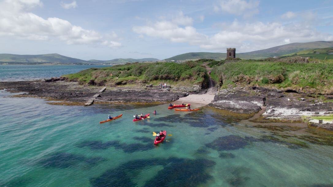 A group kayaking on Dingle Bay