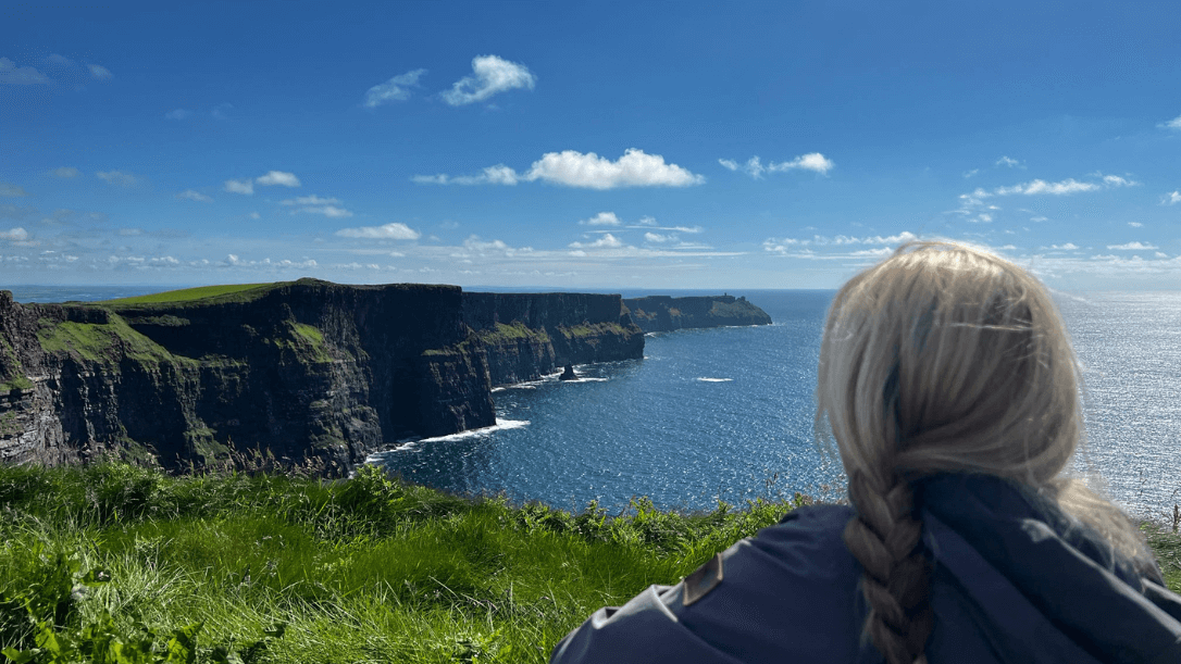 A lady overlooking the cliffs of moher