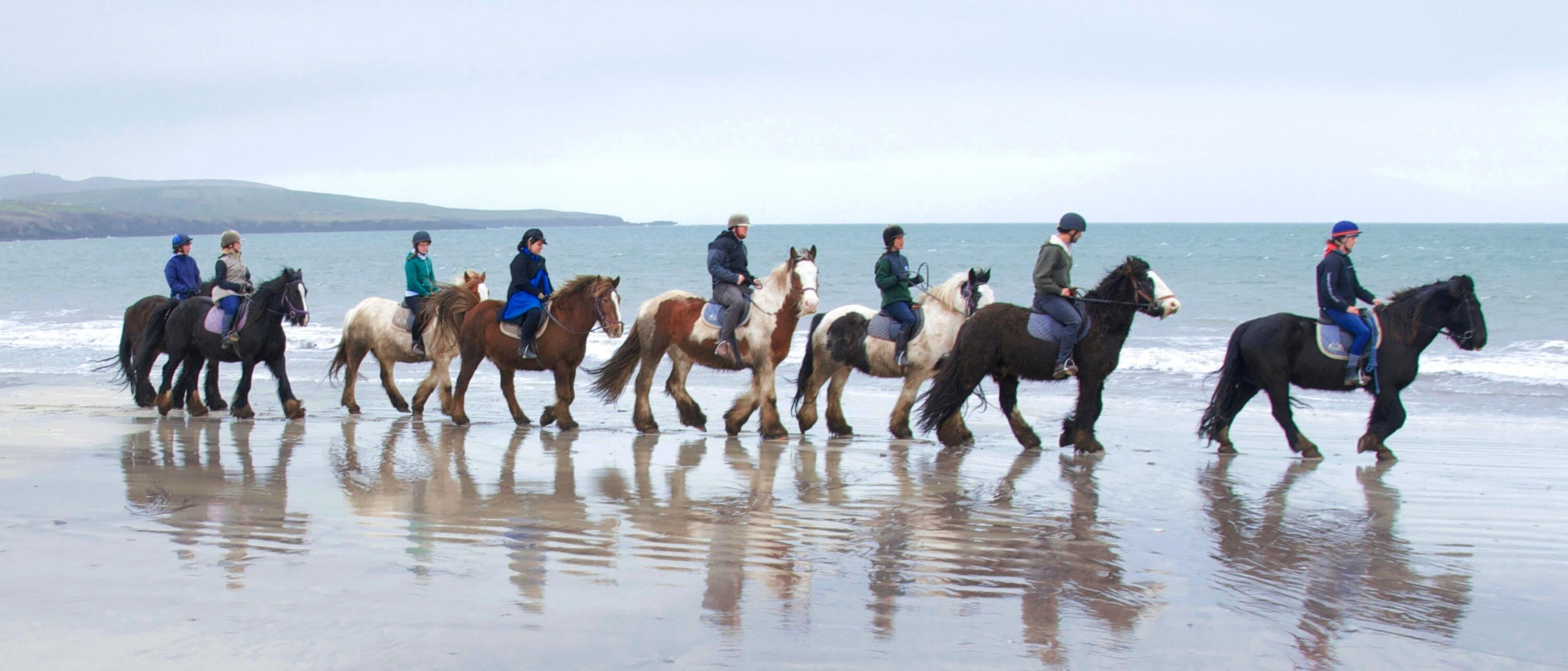 Ride horses along a wild beach on your active adventure tour of Ireland