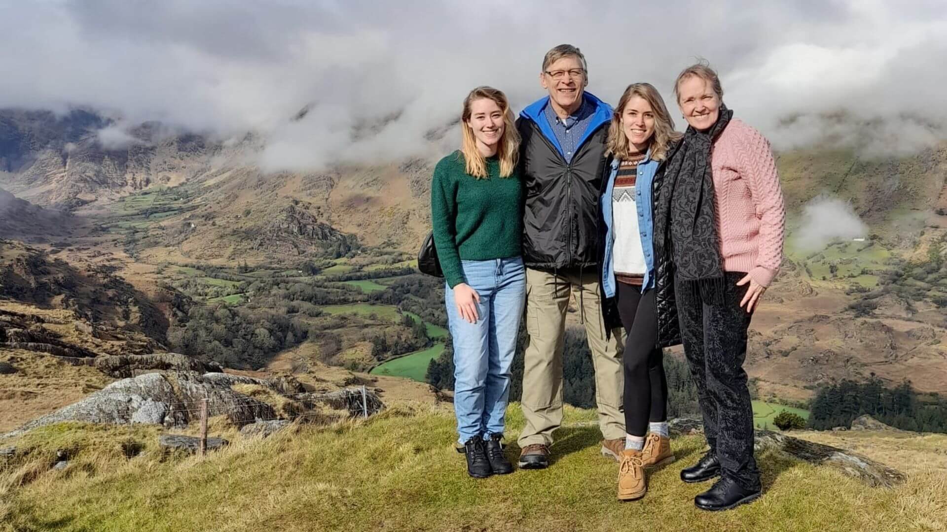 A family posing for a picture on the healy pass with mountains in the background