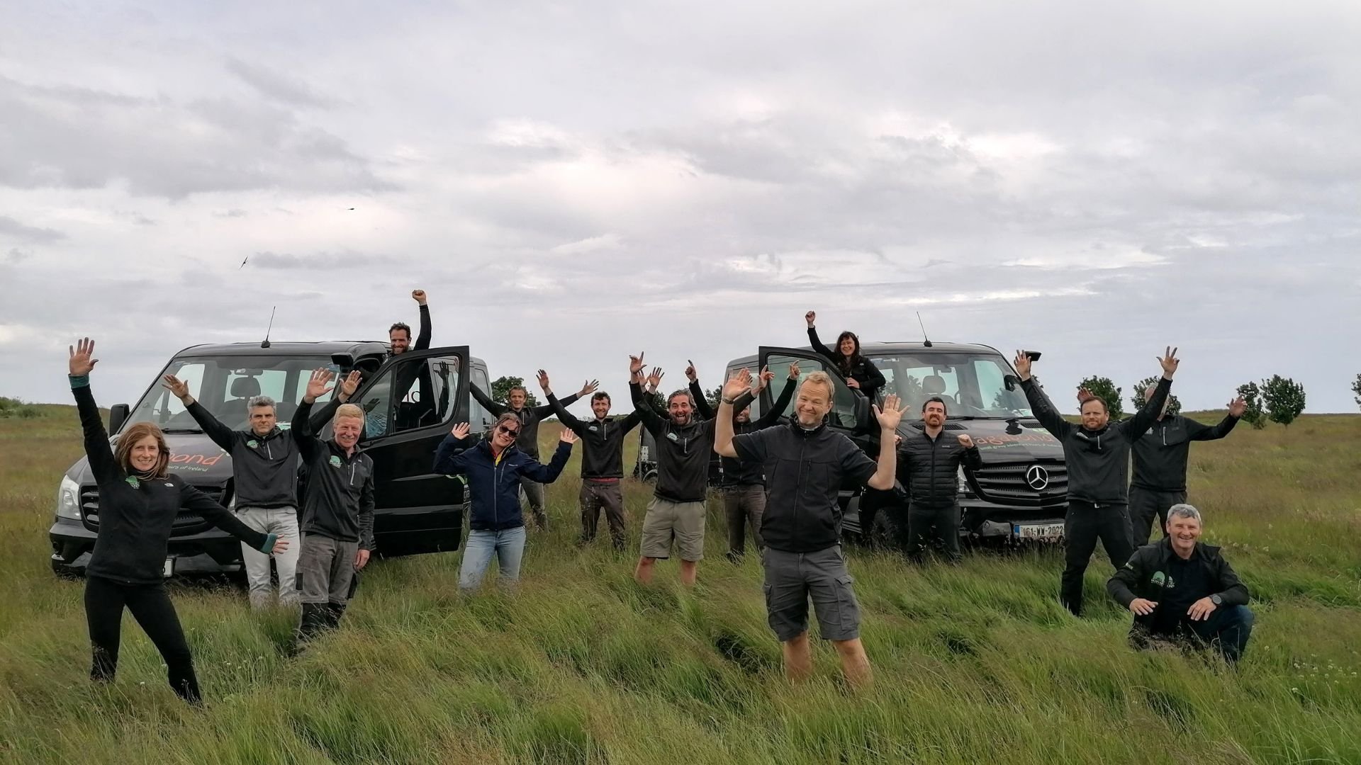 vagabond team, cheering next to vagabond vehicles]