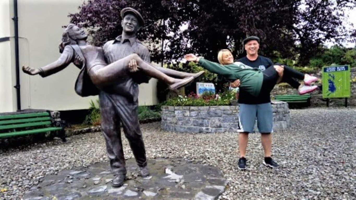 couple at the quiet man statue in Cong Ireland