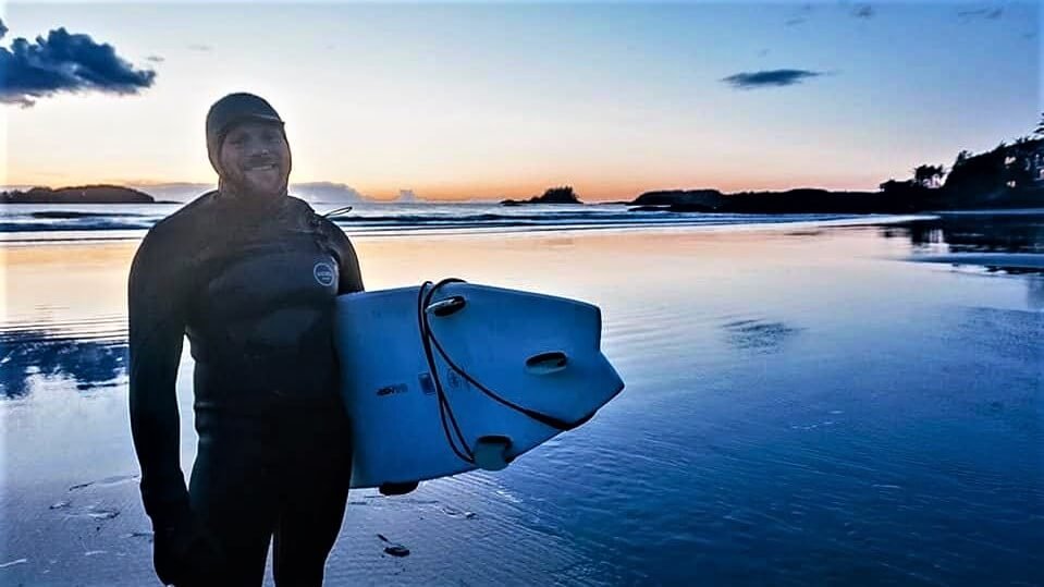 Surfer in a wetsuit on a beach