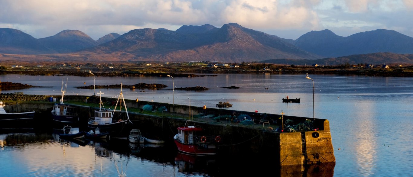 Scenic view of mountains, ocean and pier in Roundstone, Galway, Ireland